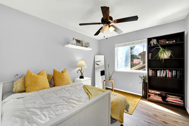 a view of a backyard with table and chairs and a barbeque