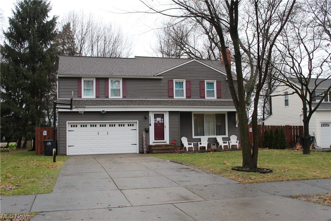 Front facade with a garage and a front lawn