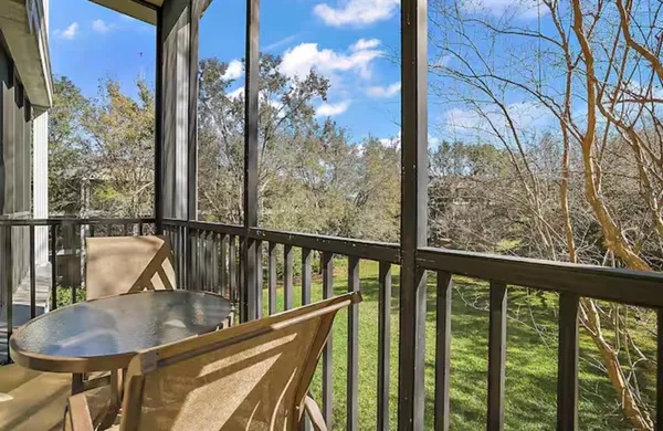 a view of a balcony with couches and wooden floor