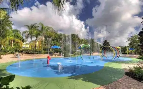 an outdoor space with swimming pool and lounge chair
