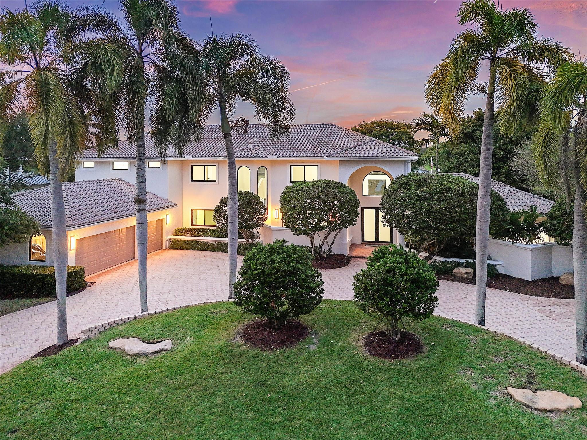 10303 Southwest 26th Street Davie, FL 33324 - Photo 2 of 42 a front view of a house with garden