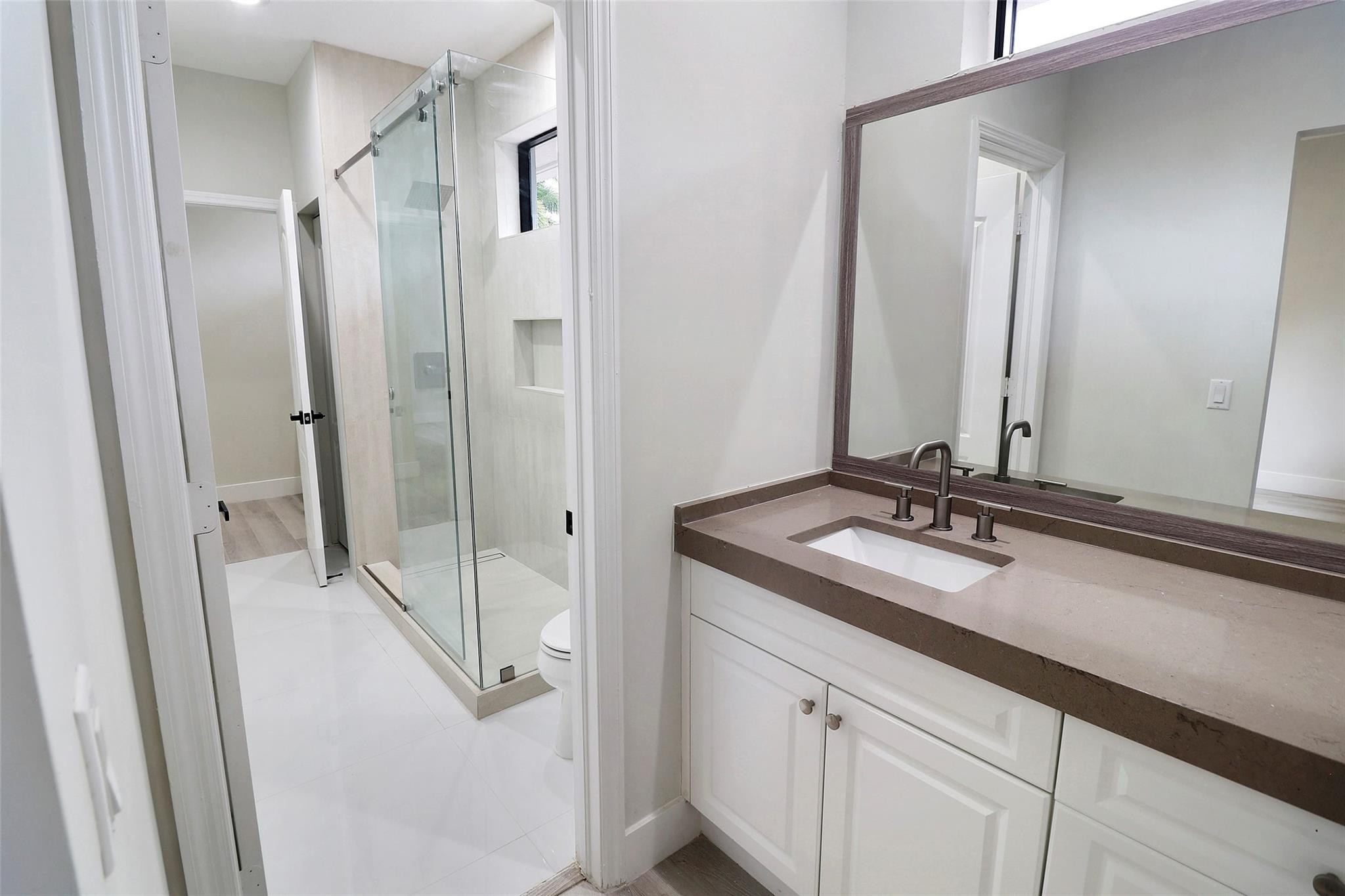 10303 Southwest 26th Street Davie, FL 33324 - Photo 32 of 42 a bathroom with a double vanity sink and mirror