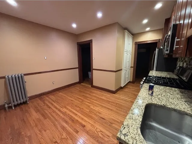 a view of a large room with wooden floor