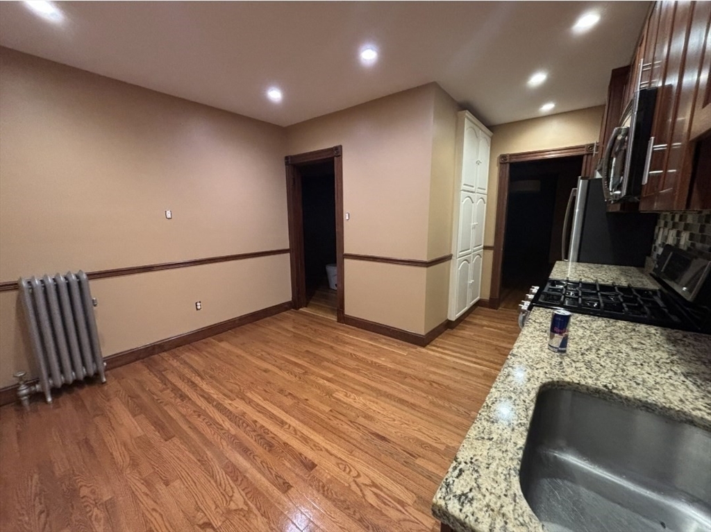 121-123 Willow Street, Unit 2 Boston, MA 02132 - Photo 2 of 8 a view of a large room with wooden floor