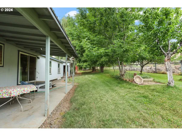 a view of a house with backyard porch and sitting area