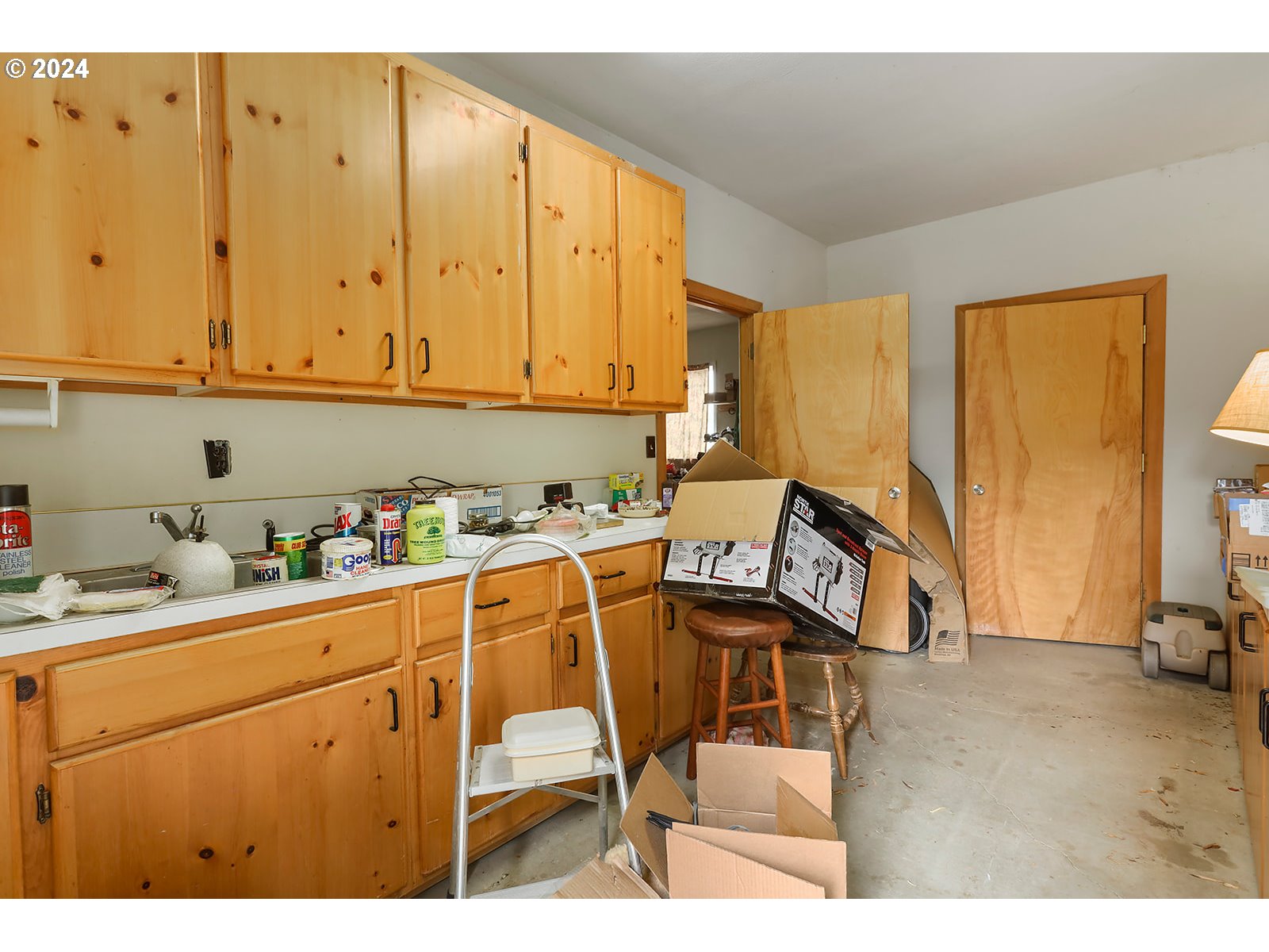 1206 Highway 197 Maupin, OR 97037 - Photo 28 of 31 a kitchen with a chair and white appliances