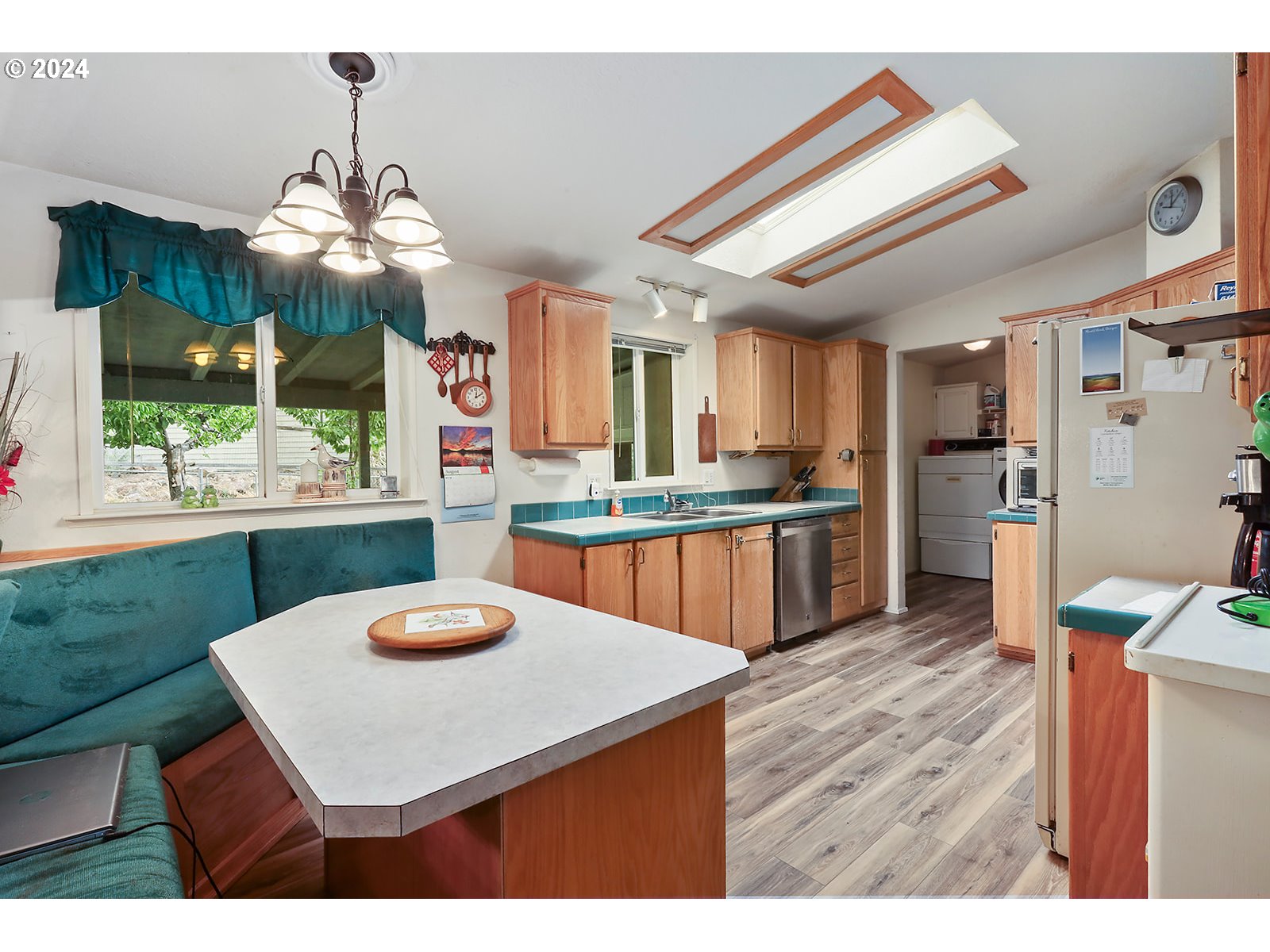 1206 Highway 197 Maupin, OR 97037 - Photo 5 of 31 a kitchen with granite countertop a stove a sink dishwasher and a refrigerator with wooden floor