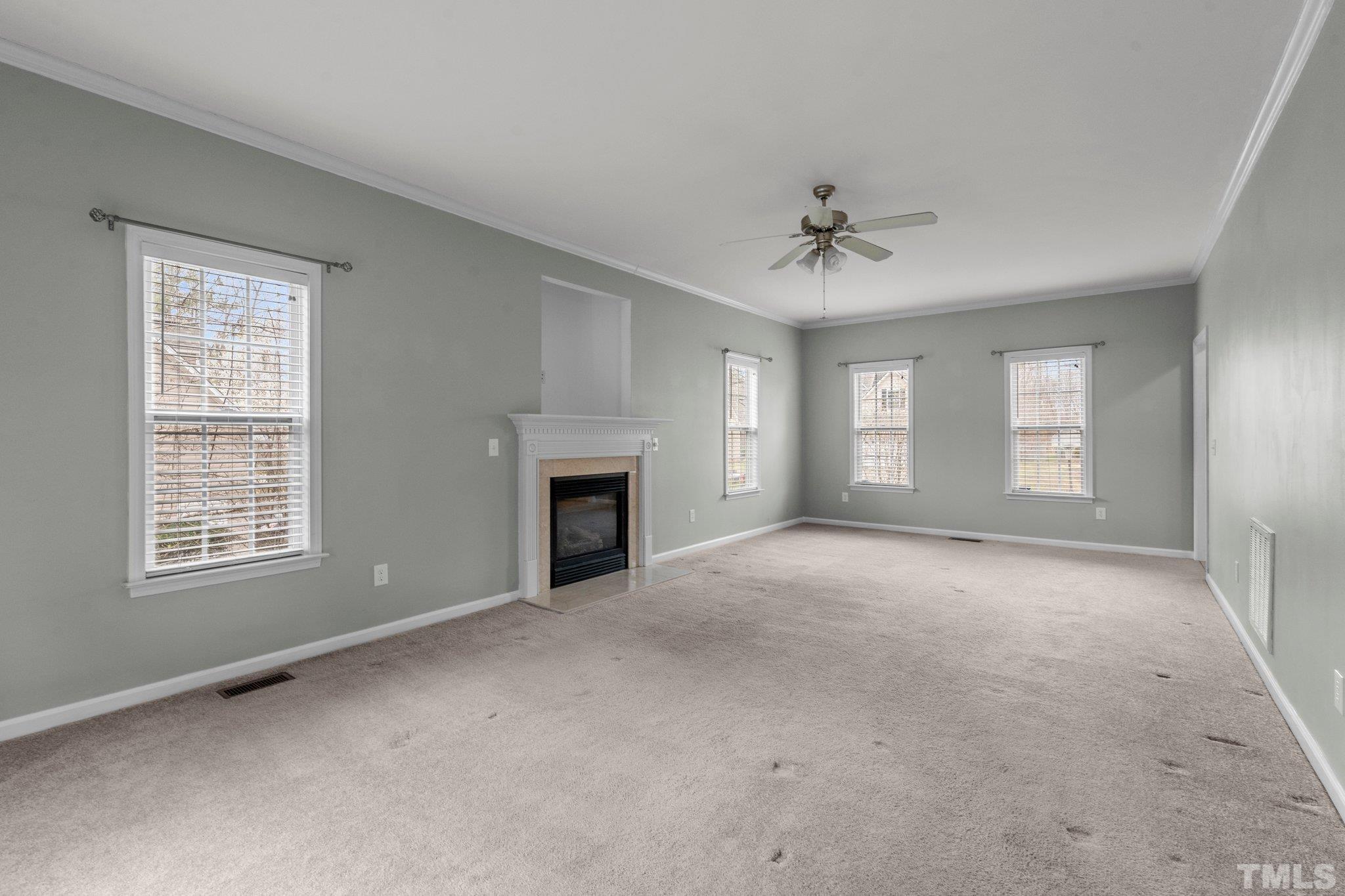 1413 Shady Rise Glen Raleigh, NC 27603 - Photo 19 of 39 an empty room with windows and ceiling fan