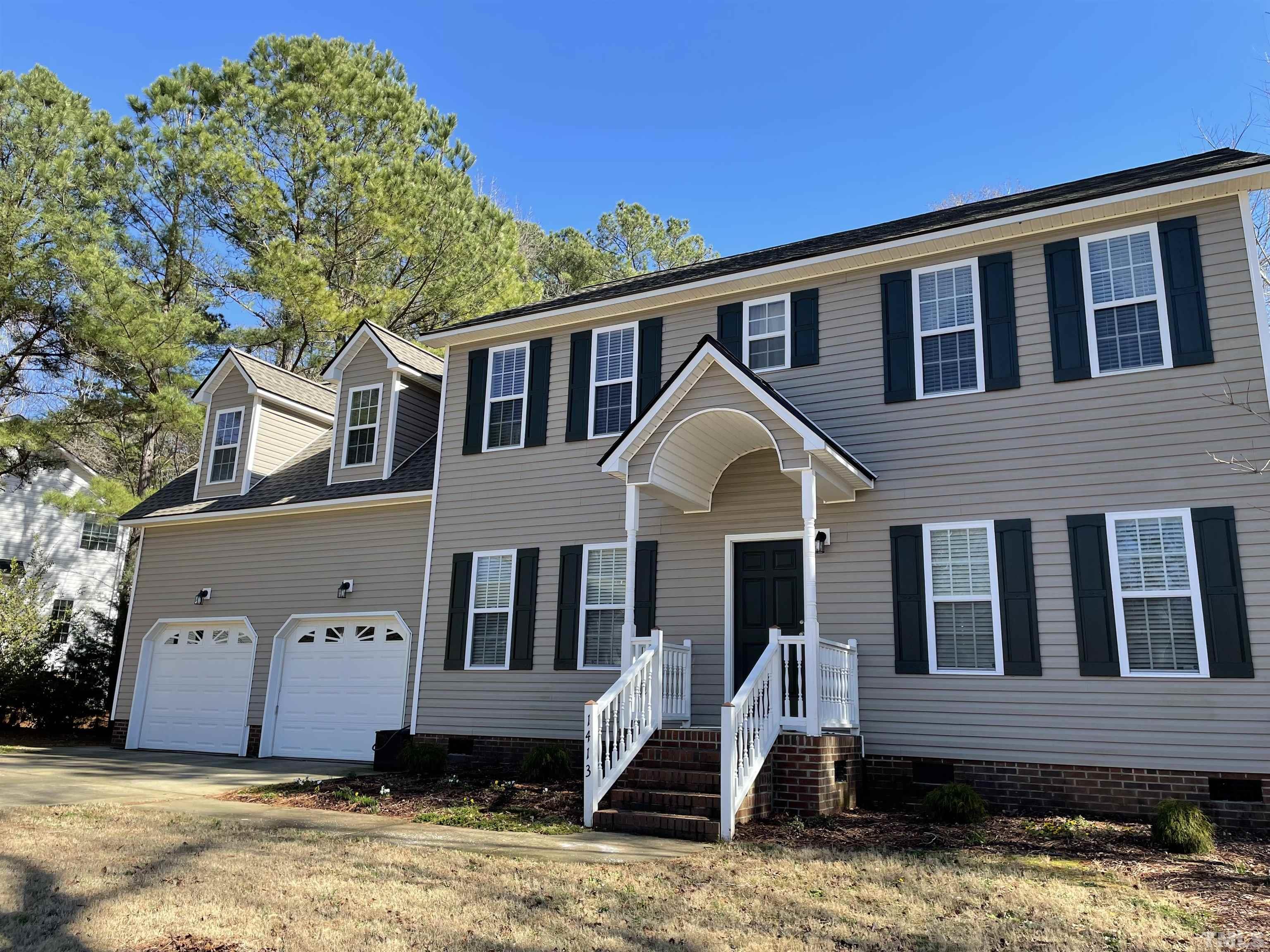 1413 Shady Rise Glen Raleigh, NC 27603 - Photo 2 of 39 a front view of a house with a yard