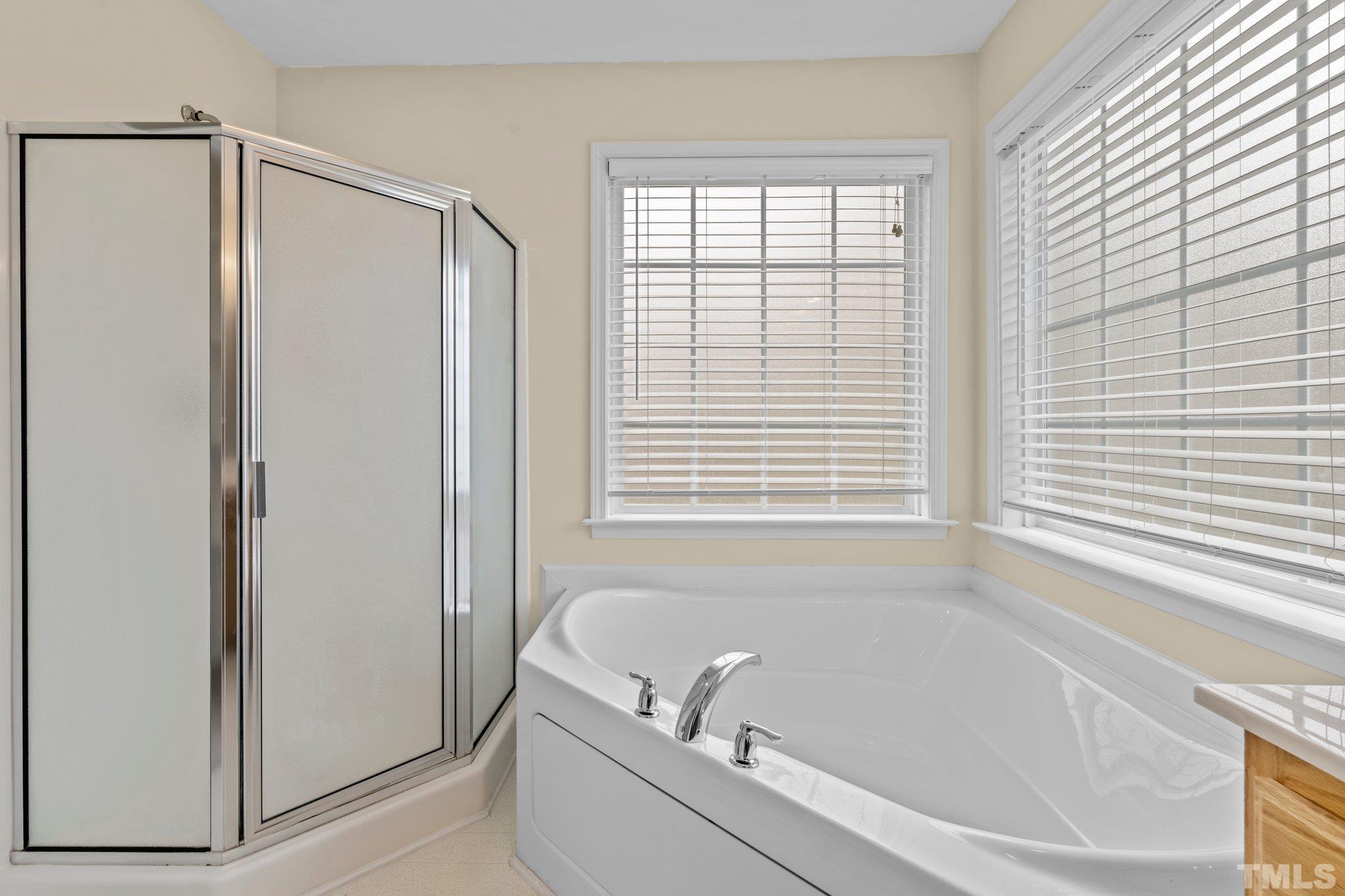 1413 Shady Rise Glen Raleigh, NC 27603 - Photo 35 of 39 a bathroom with a bathtub and a shower