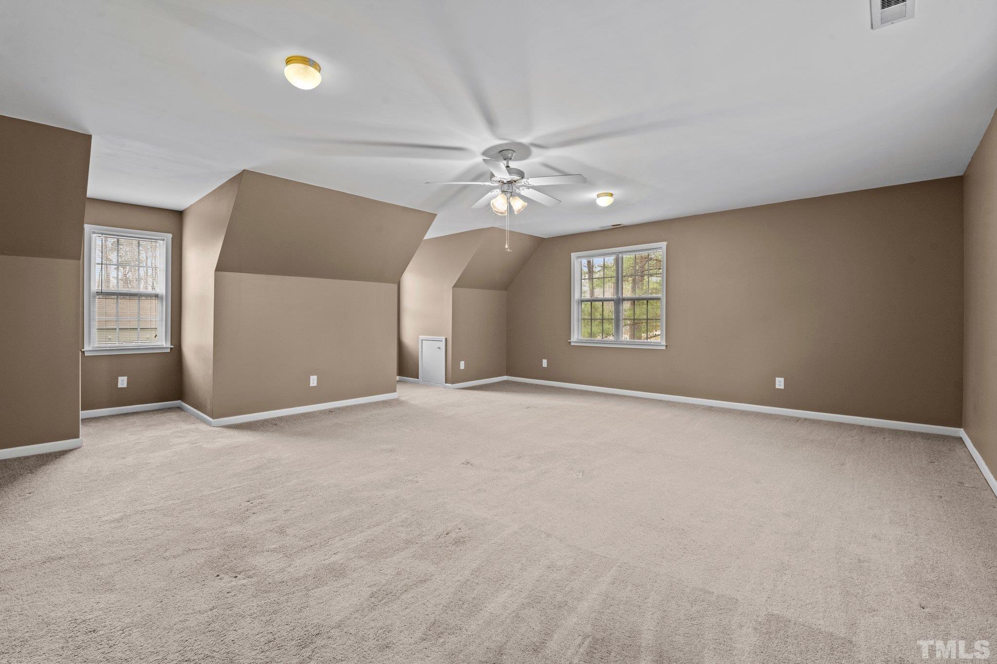 1413 Shady Rise Glen Raleigh, NC 27603 - Photo 39 of 39 an empty room with windows and ceiling fan