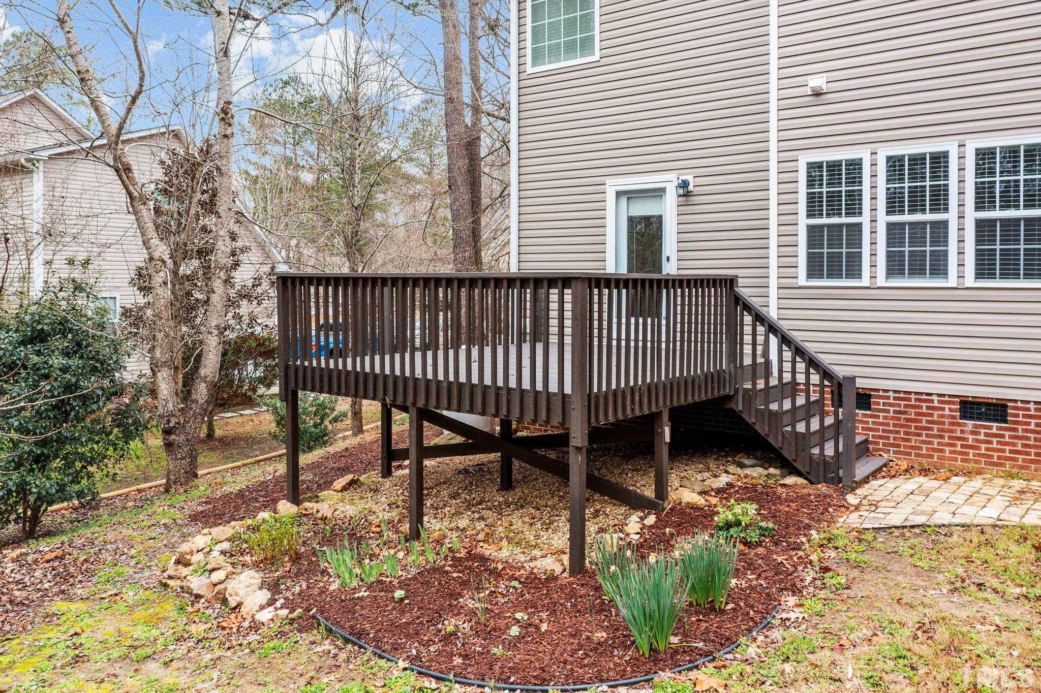 1413 Shady Rise Glen Raleigh, NC 27603 - Photo 10 of 39 a view of a roof deck with wooden fence and a floor