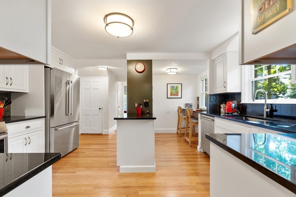 8 Monadnock Road Arlington, MA 02476 - Photo 13 of 37 a kitchen with stainless steel appliances granite countertop a refrigerator and a stove top oven