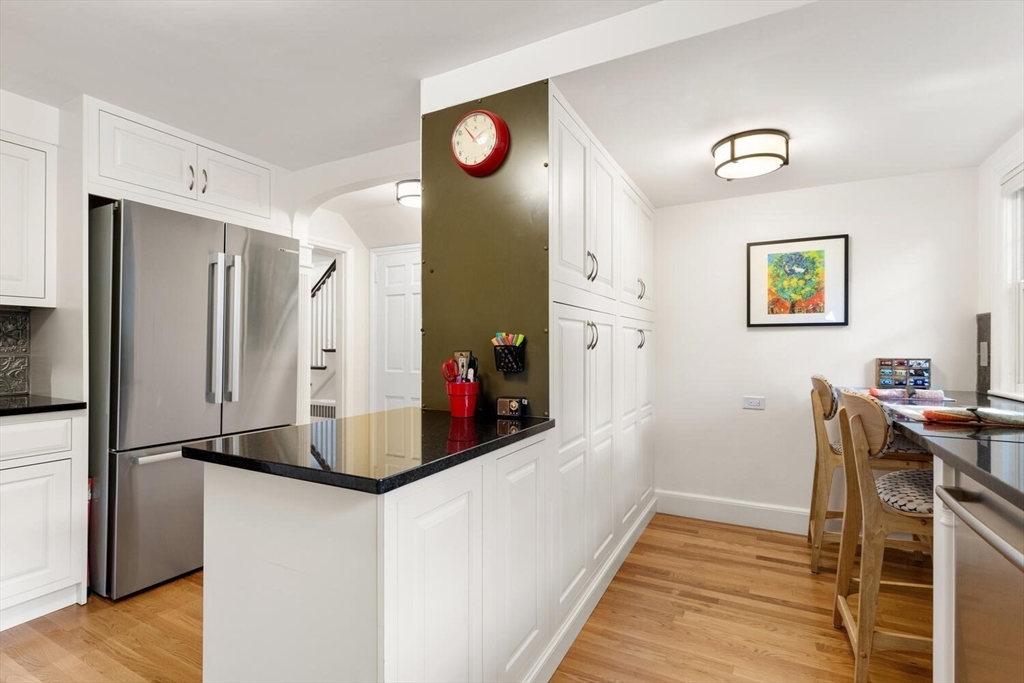 8 Monadnock Road Arlington, MA 02476 - Photo 14 of 37 a kitchen with stainless steel appliances granite countertop a refrigerator and a stove
