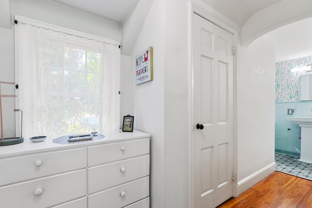 8 Monadnock Road Arlington, MA 02476 - Photo 22 of 37 a bathroom with a granite countertop sink a mirror and a shower