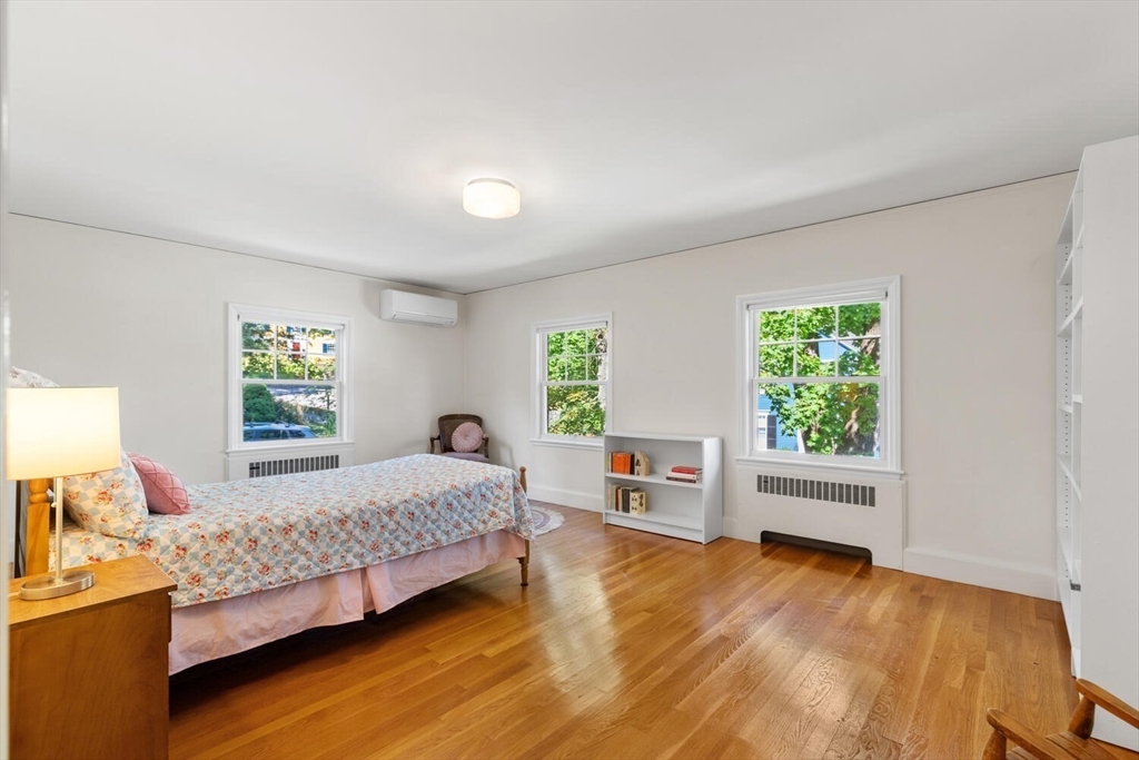 8 Monadnock Road Arlington, MA 02476 - Photo 25 of 37 a bedroom with a bed and wooden floor
