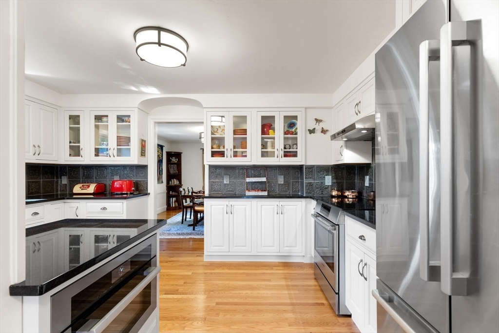 8 Monadnock Road Arlington, MA 02476 - Photo 10 of 37 a kitchen with stainless steel appliances a stove refrigerator and cabinets