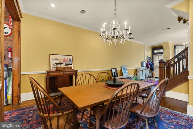 a view of a dining room with furniture and chandelier