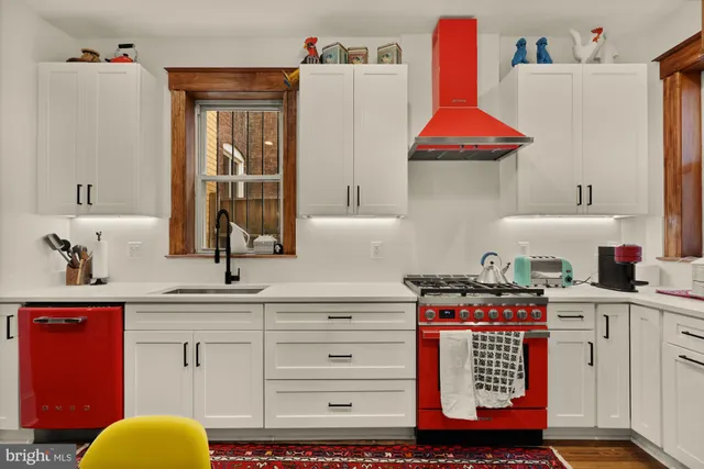a kitchen with stainless steel appliances a sink stove and cabinets