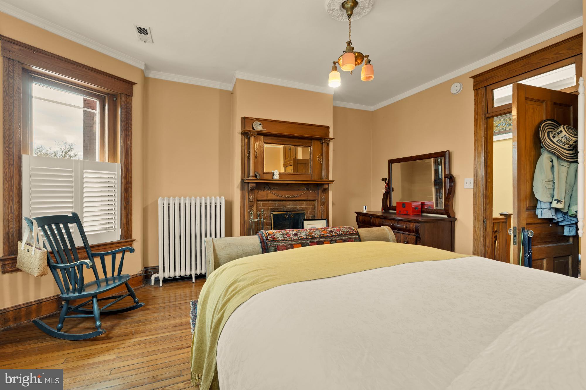 543 11th Street Southeast Washington, DC 20003 - Photo 27 of 41 a bedroom with a bed a chair and a chandelier