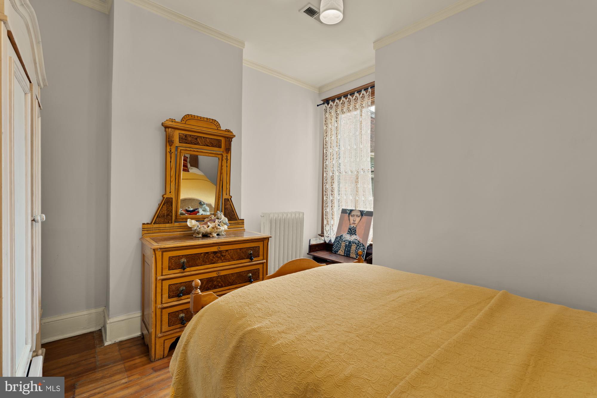 543 11th Street Southeast Washington, DC 20003 - Photo 28 of 41 a bedroom with a bed and wooden floor