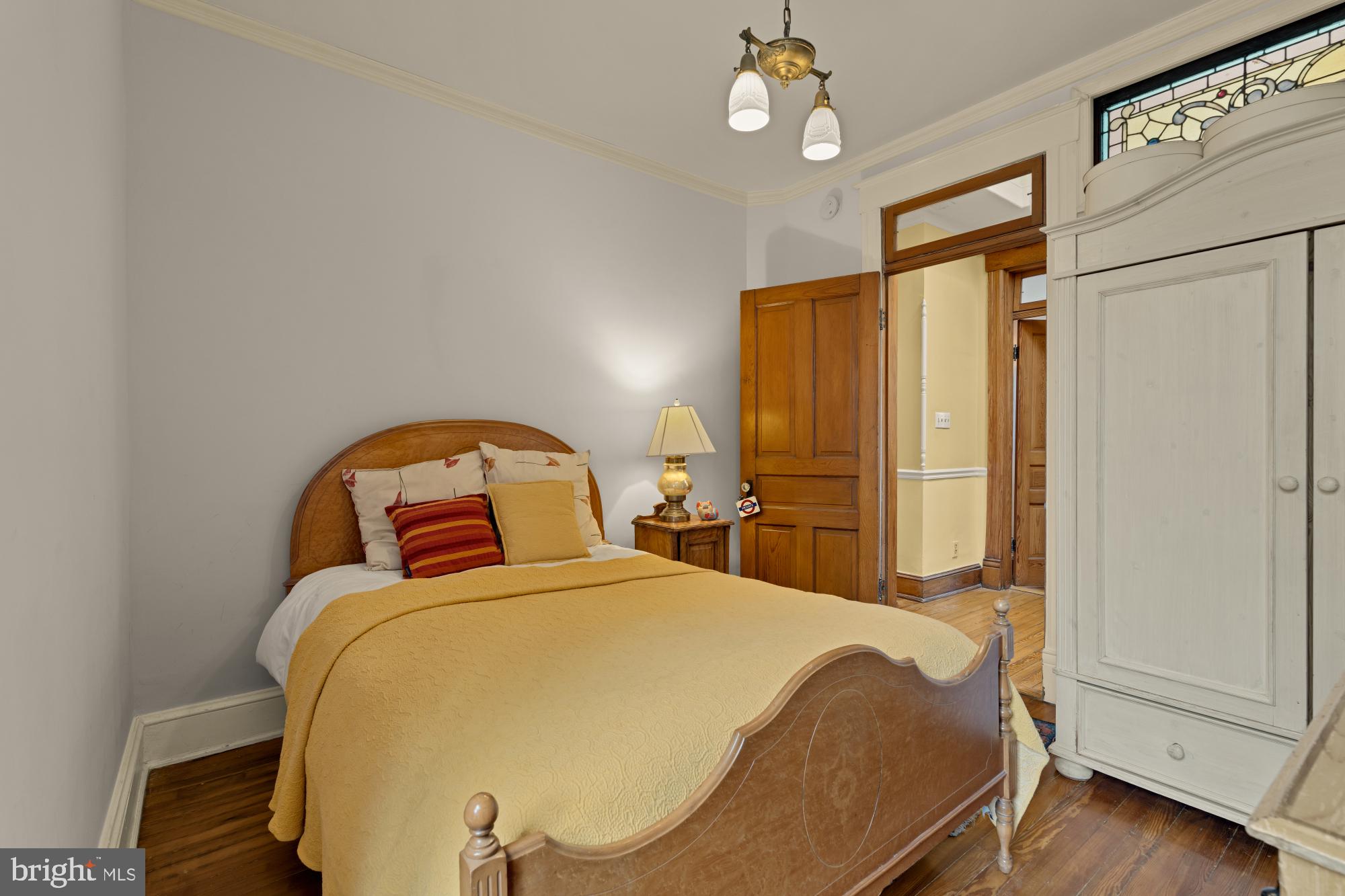 543 11th Street Southeast Washington, DC 20003 - Photo 29 of 41 a bedroom with a bed and a chandelier