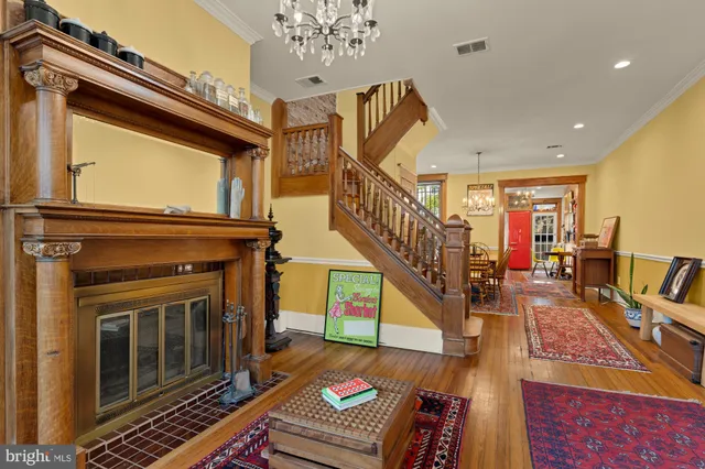 a living room with fireplace furniture and a rug