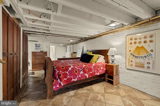 a bedroom with bed and a chandelier