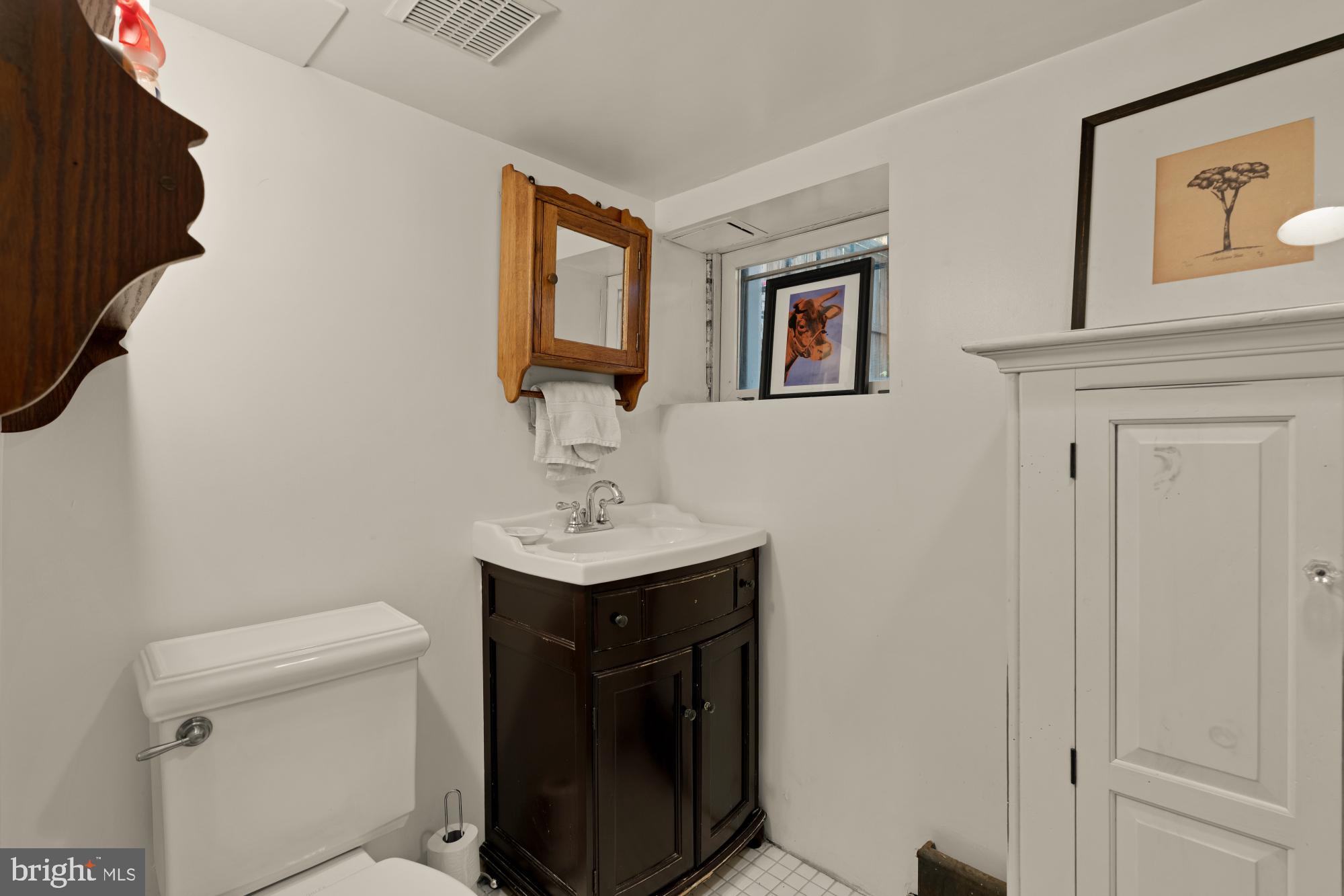 543 11th Street Southeast Washington, DC 20003 - Photo 39 of 41 a bathroom with a toilet a sink and mirror