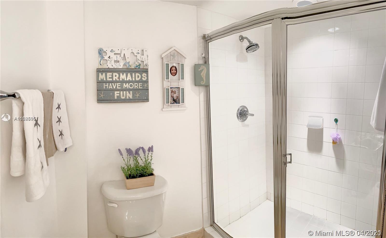 1155 Brickell Bay Drive, Unit 3008 Miami, FL 33131 - Photo 11 of 21 a bathroom with a shower a toilet and a shower