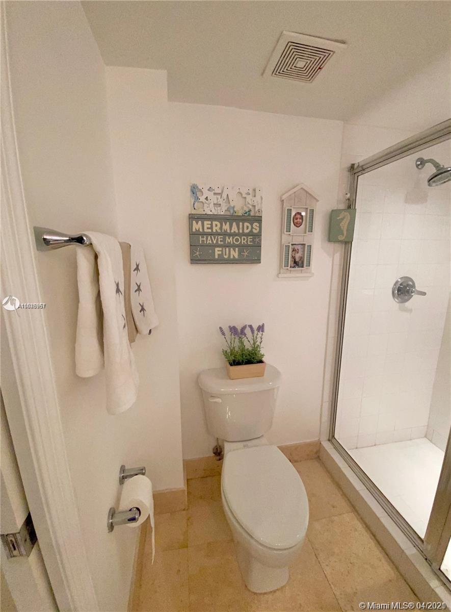 1155 Brickell Bay Drive, Unit 3008 Miami, FL 33131 - Photo 14 of 21 a white toilet sitting next to a shower