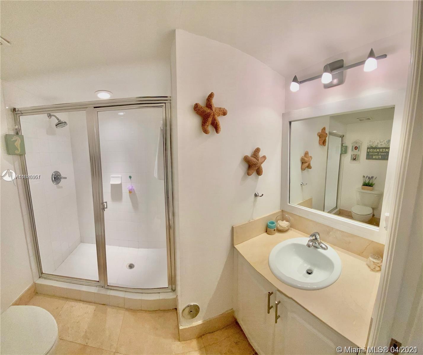 1155 Brickell Bay Drive, Unit 3008 Miami, FL 33131 - Photo 15 of 21 a bathroom with a sink a toilet and shower