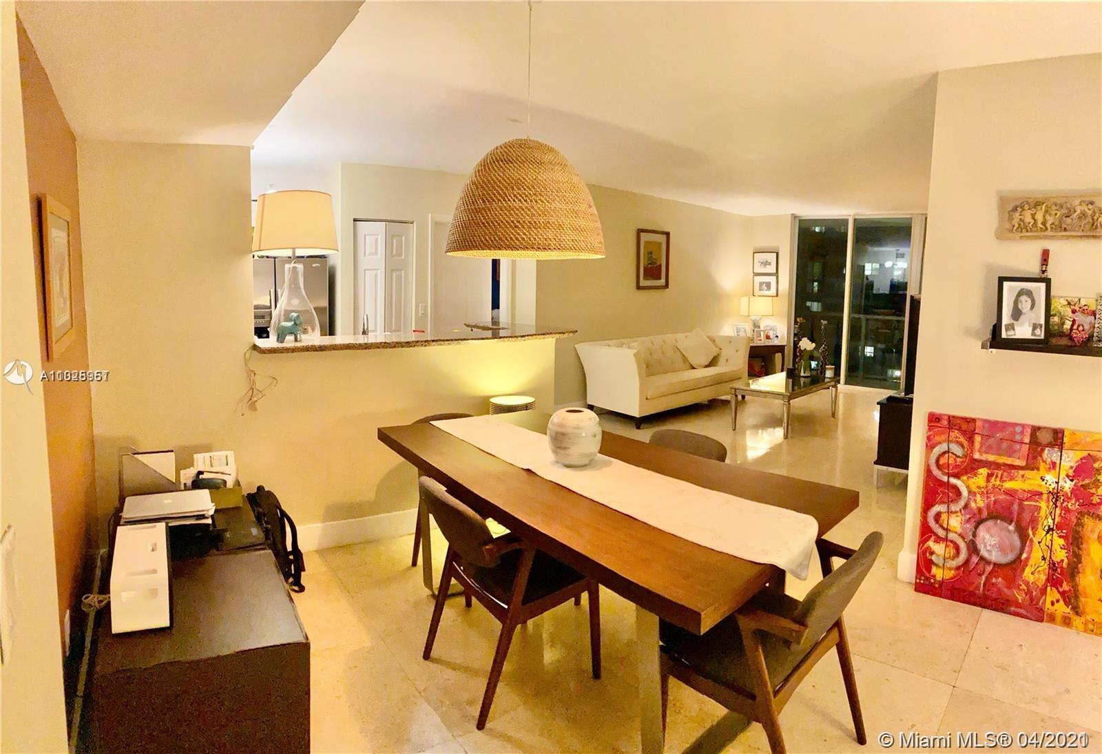 1155 Brickell Bay Drive, Unit 3008 Miami, FL 33131 - Photo 16 of 21 a view of a dining room with furniture and a wooden floor