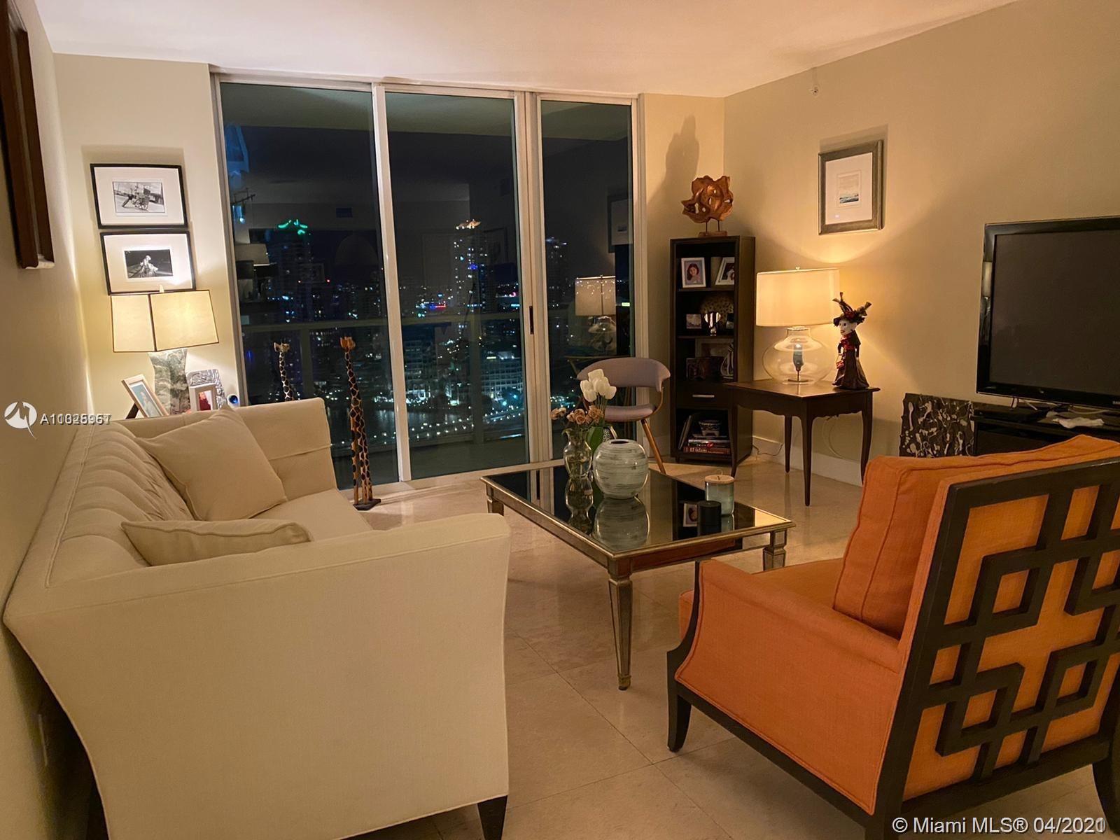 1155 Brickell Bay Drive, Unit 3008 Miami, FL 33131 - Photo 5 of 21 a living room with furniture and a flat screen tv