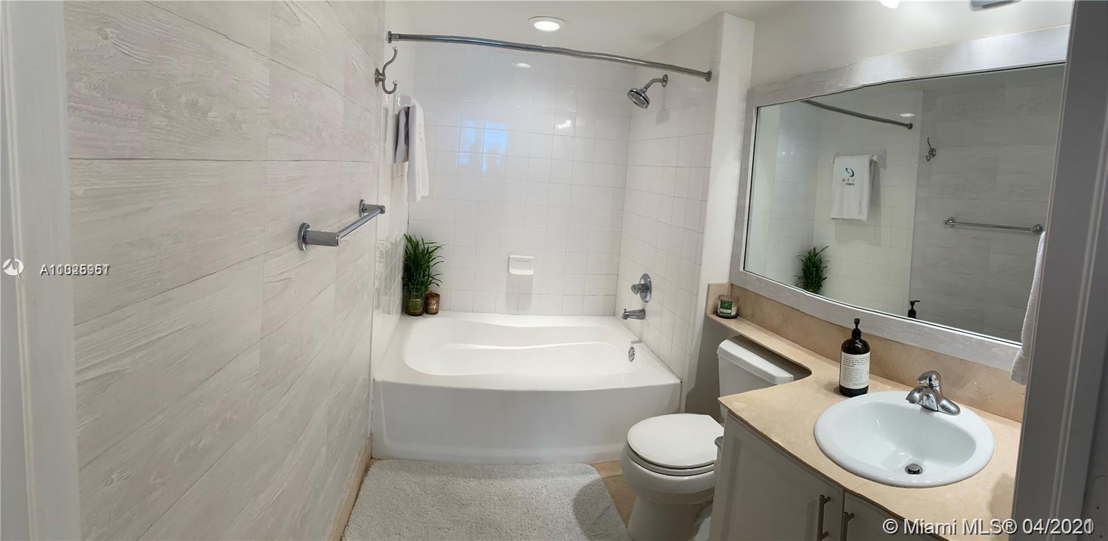 1155 Brickell Bay Drive, Unit 3008 Miami, FL 33131 - Photo 7 of 21 a bathroom with a sink toilet and shower