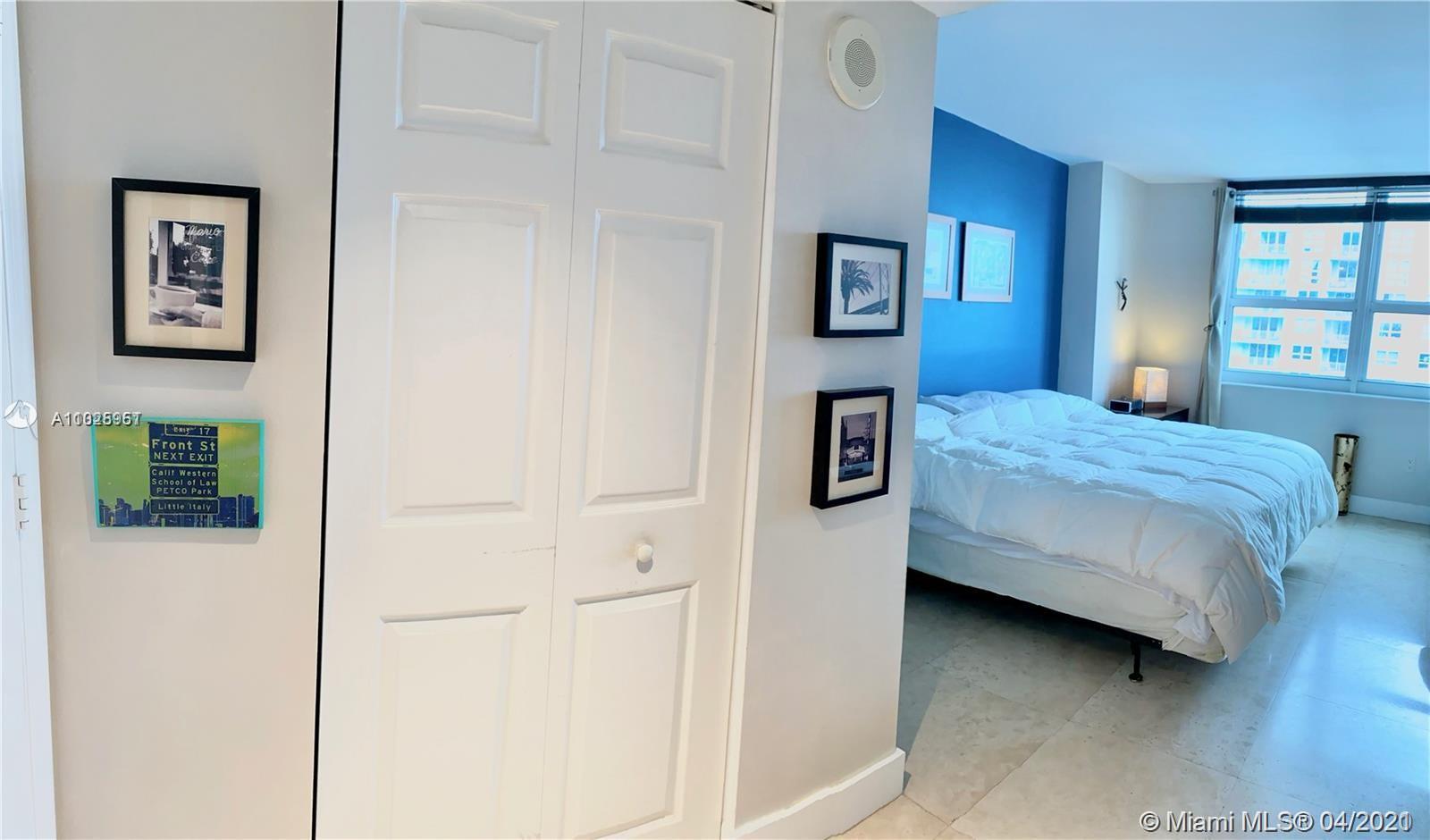 1155 Brickell Bay Drive, Unit 3008 Miami, FL 33131 - Photo 10 of 21 a bedroom with a bed and a cabinets