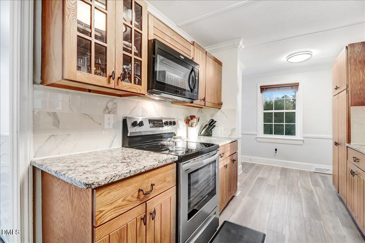313 South 4th Street Smithfield, NC 27577 - Photo 11 of 31 a kitchen with stainless steel appliances granite countertop a stove and a microwave