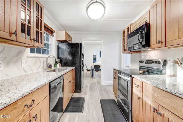 a kitchen with stainless steel appliances granite countertop a stove and a sink