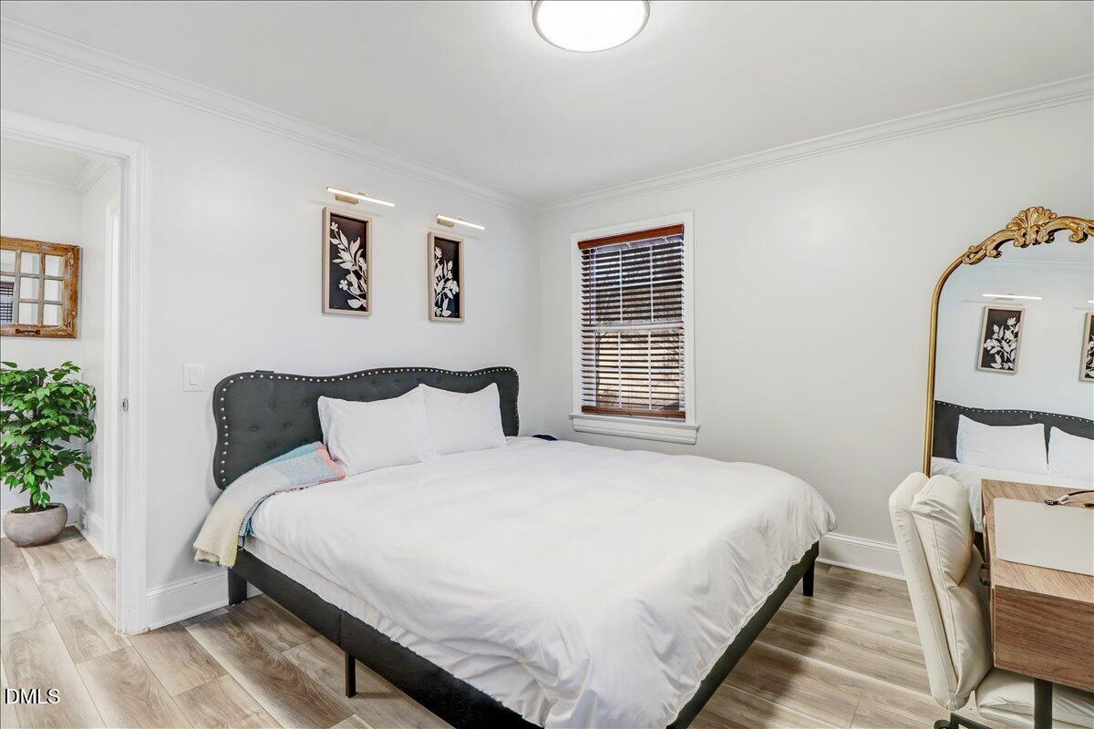 313 South 4th Street Smithfield, NC 27577 - Photo 15 of 31 a bedroom with a bed and wooden floor