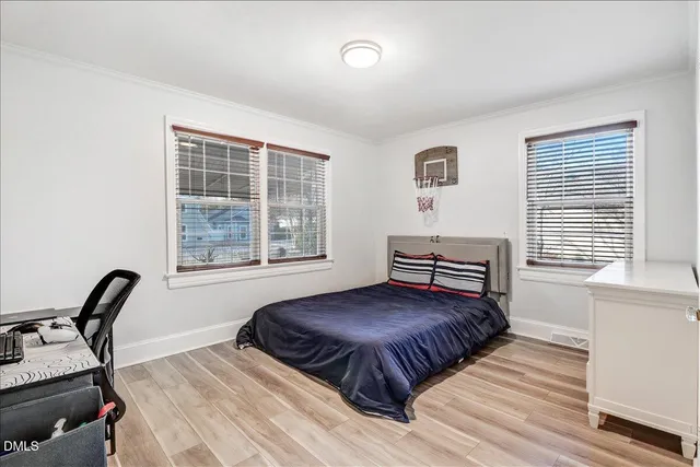 a bedroom with a bed window and flat screen tv