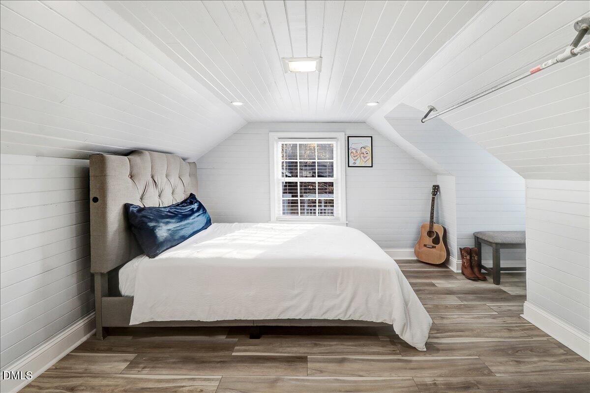 313 South 4th Street Smithfield, NC 27577 - Photo 23 of 31 a bedroom with a large bed and wooden floor