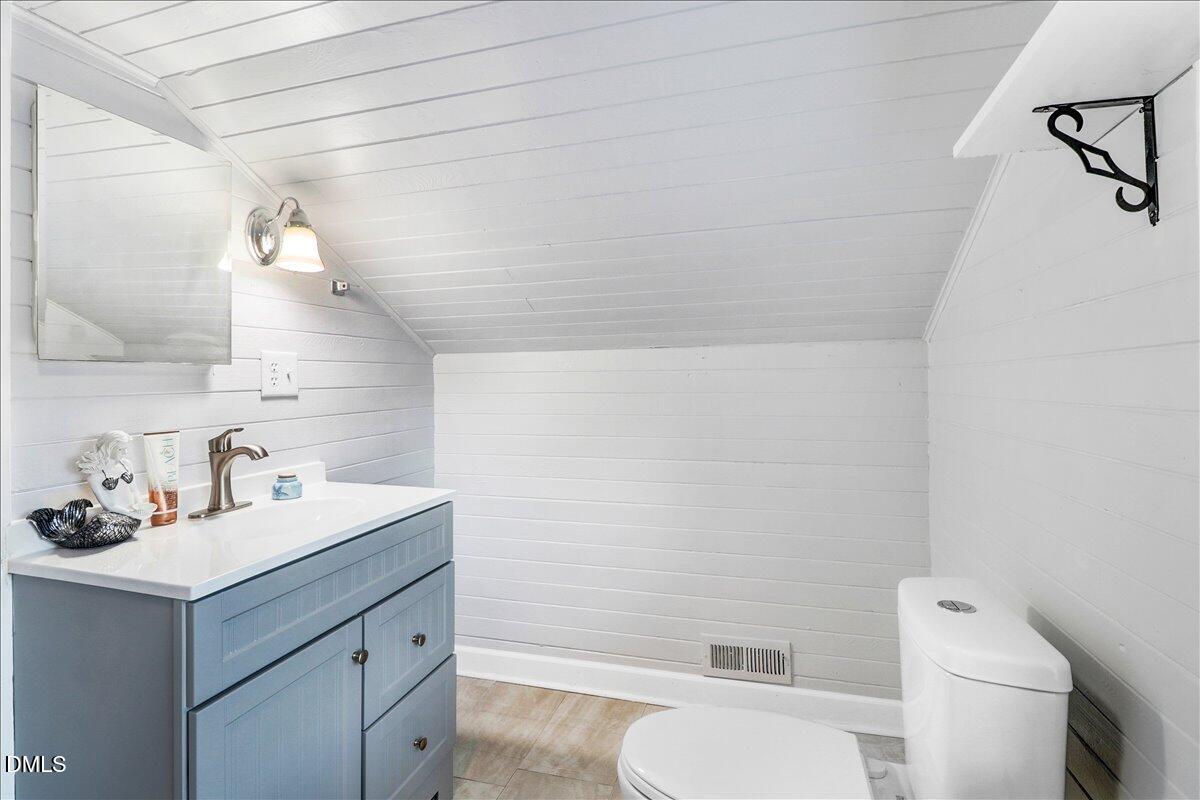 313 South 4th Street Smithfield, NC 27577 - Photo 25 of 31 a bathroom with a sink vanity mirror and toilet