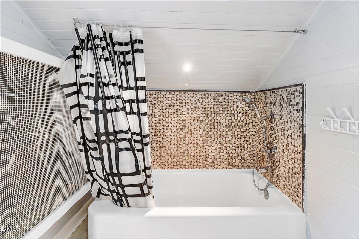 313 South 4th Street Smithfield, NC 27577 - Photo 26 of 31 a bathroom with a bathtub and a shower