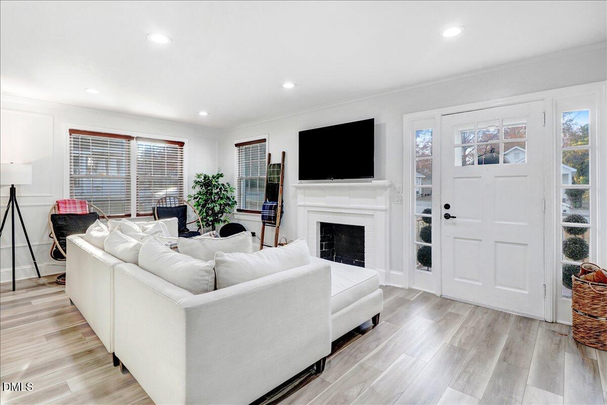 313 South 4th Street Smithfield, NC 27577 - Photo 5 of 31 a living room with furniture a fireplace and a flat screen tv