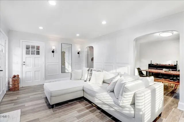 a living room with furniture and a potted plant