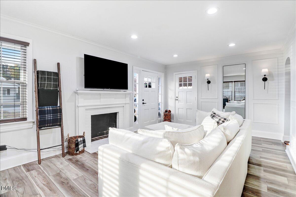 313 South 4th Street Smithfield, NC 27577 - Photo 7 of 31 a living room with fireplace furniture and a flat screen tv