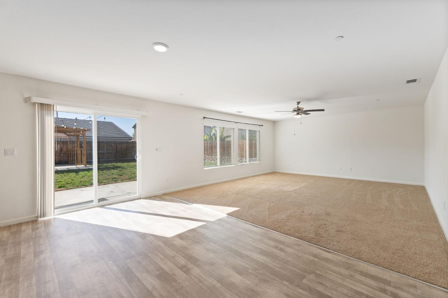 802 Riesling Lane Coalinga, CA 93210 - Photo 12 of 68 a view of an empty room with wooden floor and a window