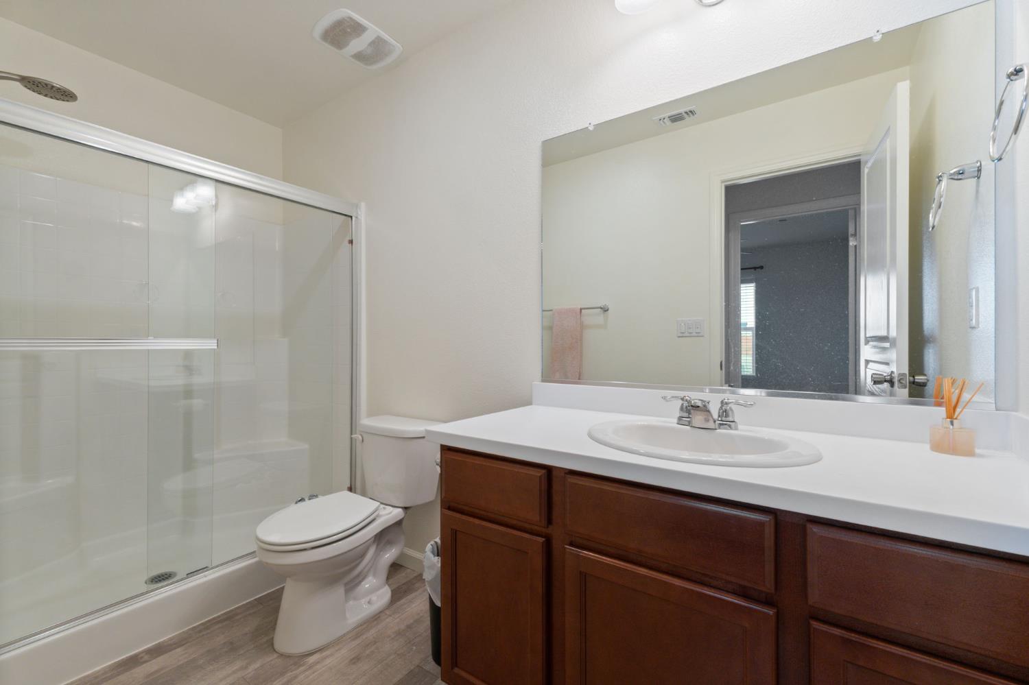 802 Riesling Lane Coalinga, CA 93210 - Photo 14 of 68 a bathroom with a sink a toilet and shower
