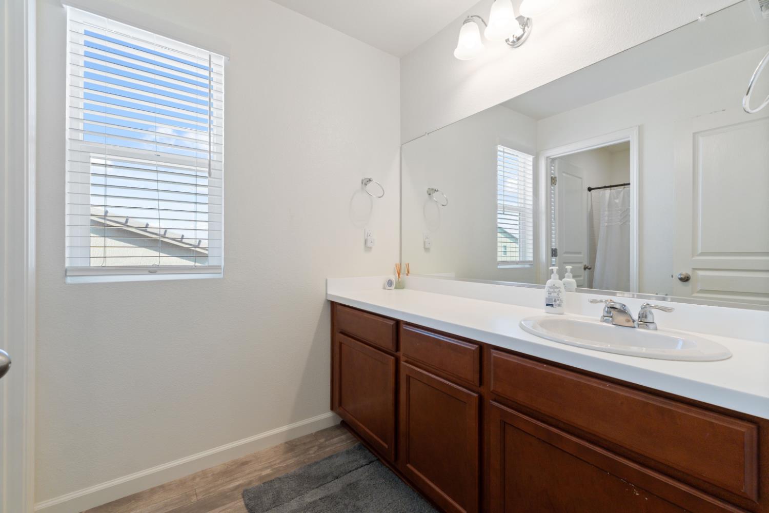 802 Riesling Lane Coalinga, CA 93210 - Photo 18 of 68 a bathroom with a double vanity sink and mirror