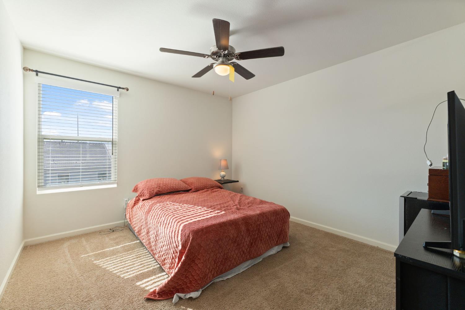 802 Riesling Lane Coalinga, CA 93210 - Photo 23 of 68 a bedroom with a bed and a flat tv screen on the dresser